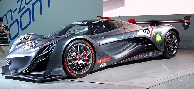 Mazda Furai concept car, 2-door coupé with butterfly doors, MR layout, built on Courage C65 LMP2 platform, featuring a 450 hp 3-rotor engine, sleek aerodynamic design, and futuristic styling.