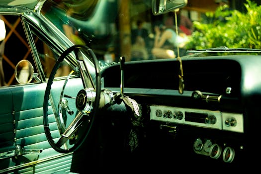 A classic vintage car interior showcasing the steering wheel and dashboard.