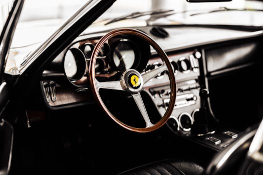 A detailed view of a vintage Ferrari interior showcasing a wooden steering wheel and classic dashboard design.