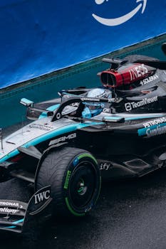 Close-up of a Formula 1 race car making a turn on a wet track during a race event.