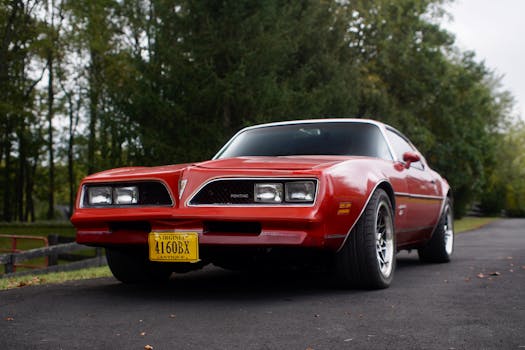 A vintage red Pontiac Firebird parked outdoors in Virginia, capturing classic American muscle car design.