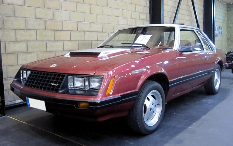 Red 1980 Ford Mustang parked inside a garage