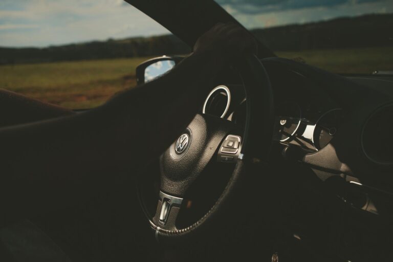 VW Taos Close-up of a car interior with a focus on the steering wheel and dashboard.