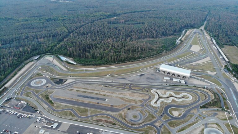 An aerial view of a race track in the middle of a forest