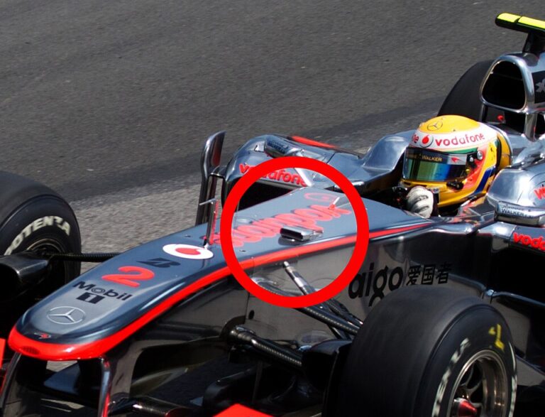 Lewis Hamilton driving for McLaren during the 2010 Canadian Grand Prix, captured in motion on a sunny race day