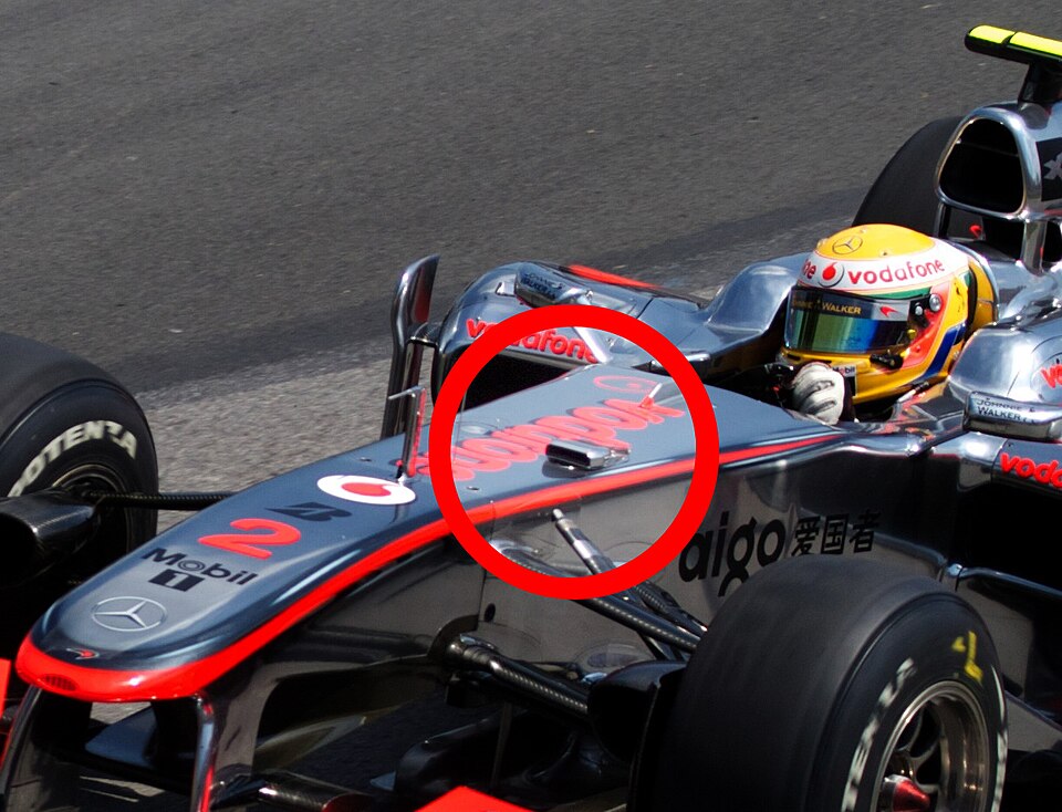 Lewis Hamilton driving for McLaren during the 2010 Canadian Grand Prix, captured in motion on a sunny race day