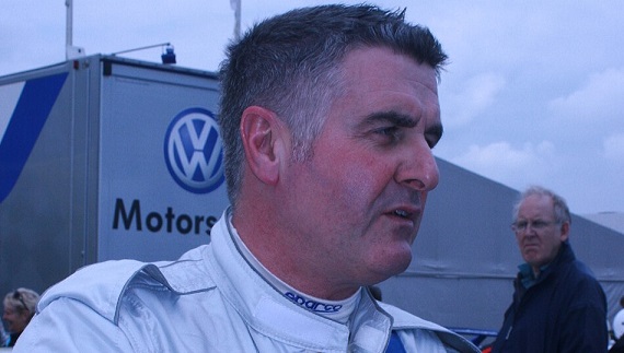 Martin Donnelly photographed after his F1 career, wearing racing gear at a motorsport event.