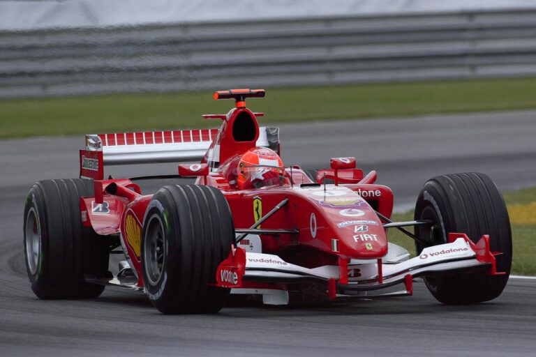 Michael Schumacher Ferrari Formula 1 car racing at high speed on the Indianapolis track, showcasing motorsport excitement.