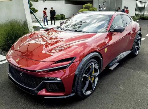 Ferrari Purosangue in classic red, showcasing sleek SUV-sports car hybrid design