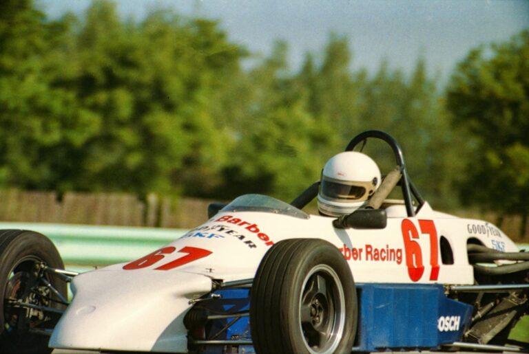 Close-up of a race car on the Elkhart Lake circuit, showcasing speed and precision.