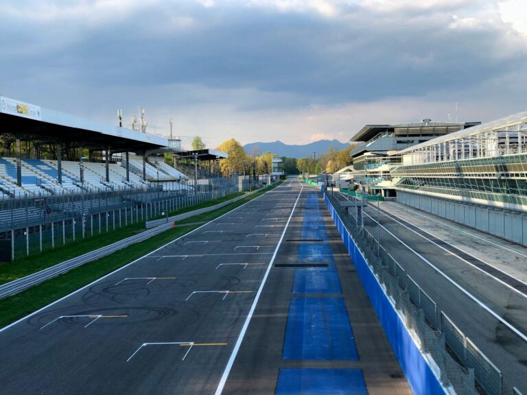 The empty pit straight at Monza Circuit in Italy, captured in serene afternoon light.